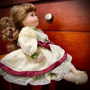 Pretty Porcelain Doll in a Sitting Position with Pretty Dress